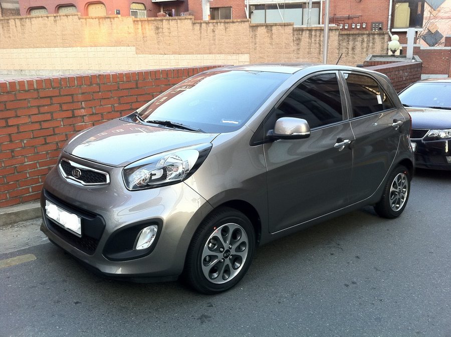A real photograph of a grey hatchback taken outdoors.